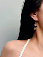 TT original-earring-Black onyx gold pendant earrings | Elegant and unique women's jewelry | French hook-shaped lantern pendant earrings