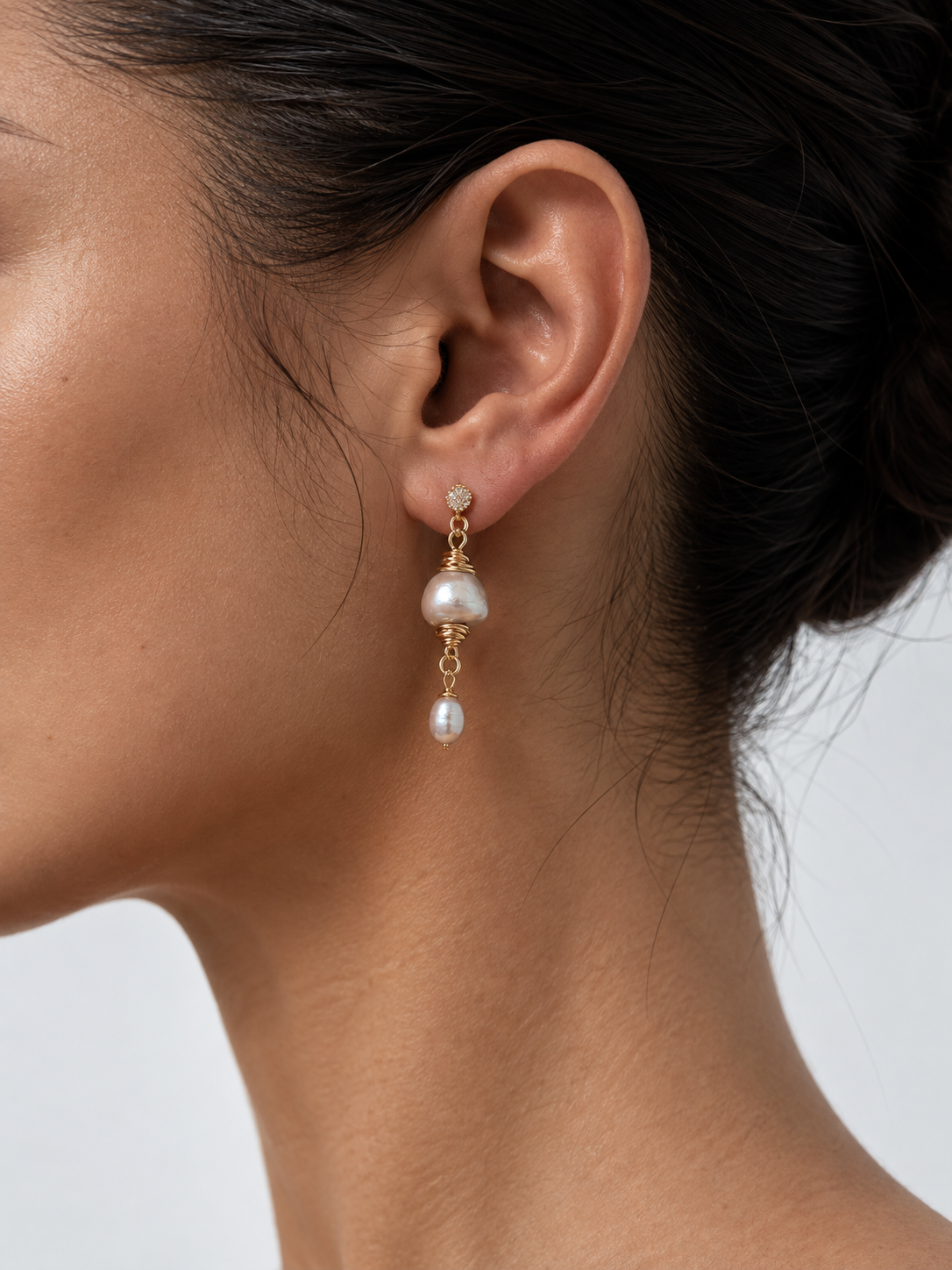 woman wearing baroque pearl earrings