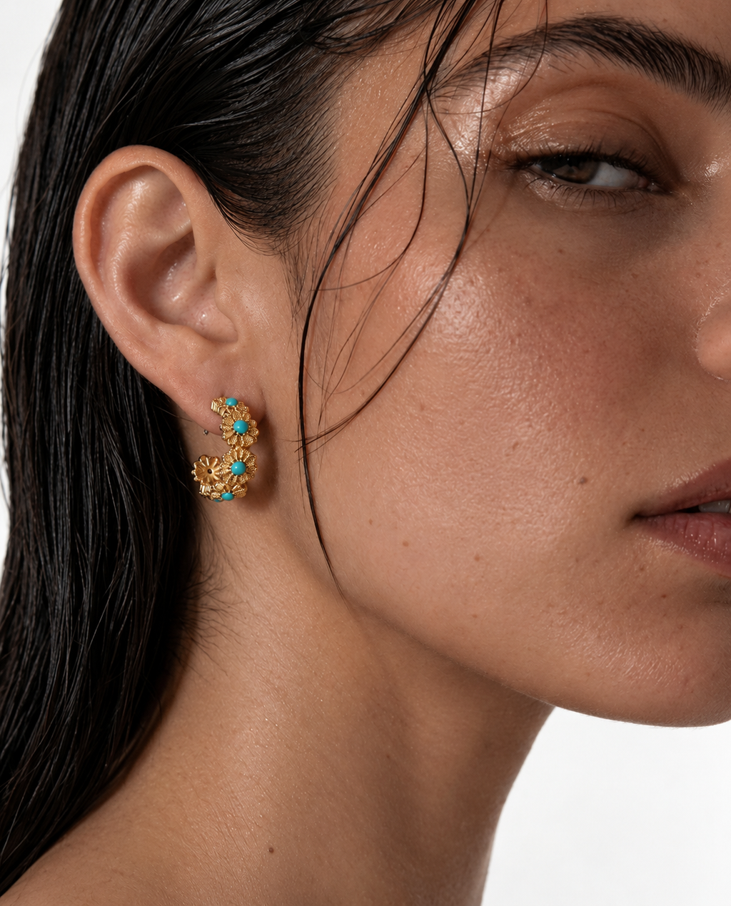 woman wearing turquoise gold hoop earrings