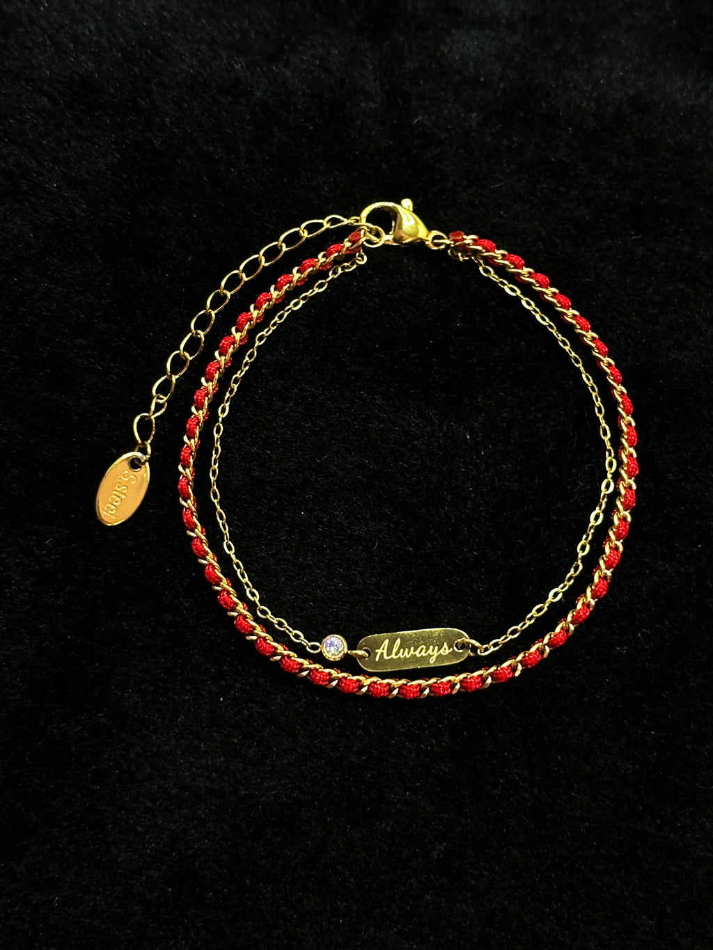 Always engraved charm on a red string bracelet