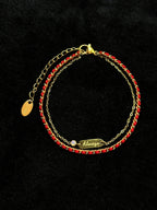 Always engraved charm on a red string bracelet
