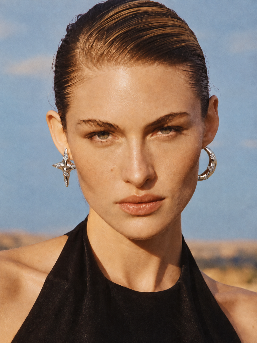 woman wearing asymmetrical moon star earrings