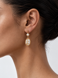 woman wearing baroque pearl drop earrings