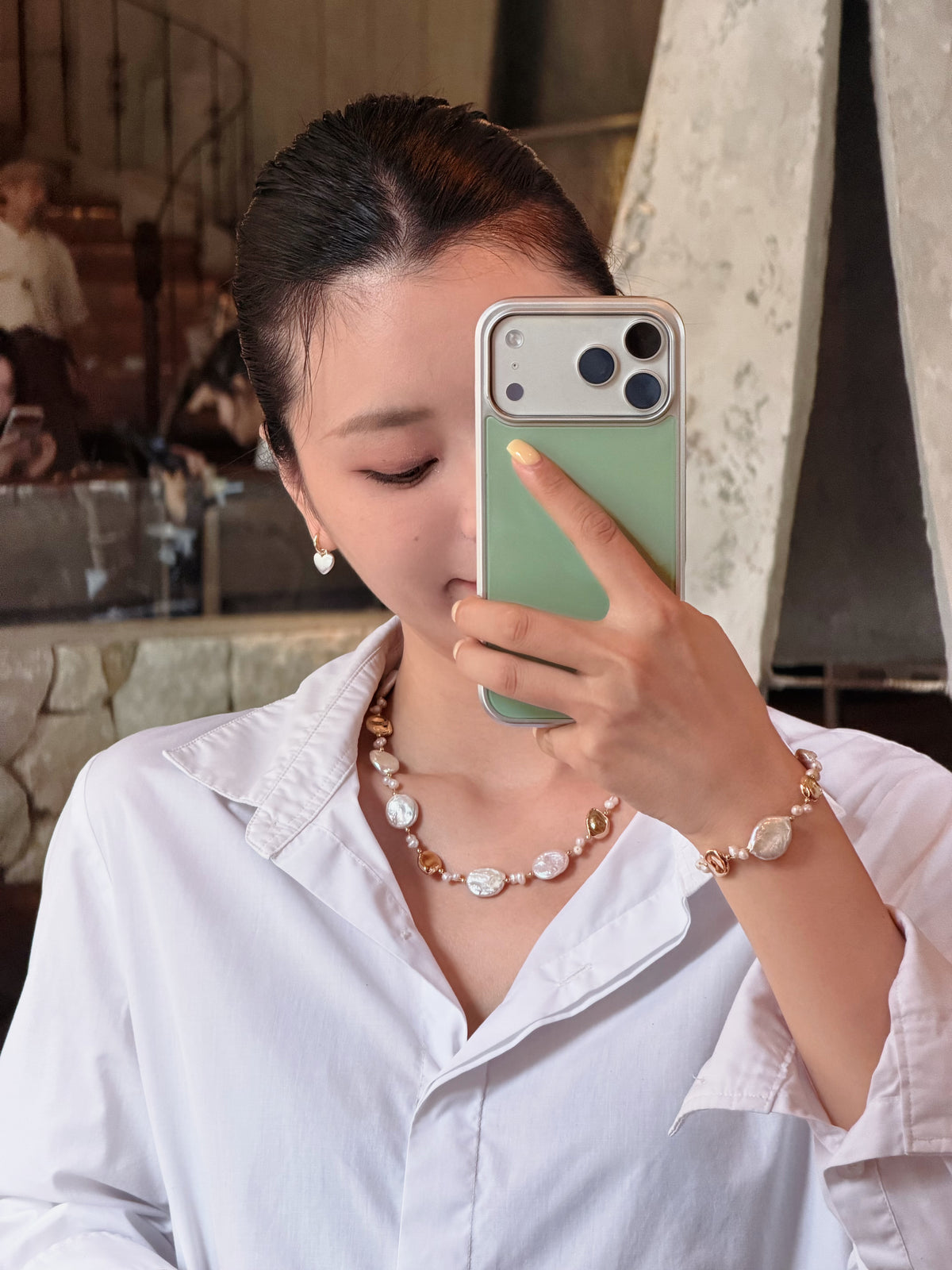 Baroque pearl necklace bracelet with gold accents worn with an everyday outfit