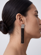 woman wearing long black agate tassel earrings