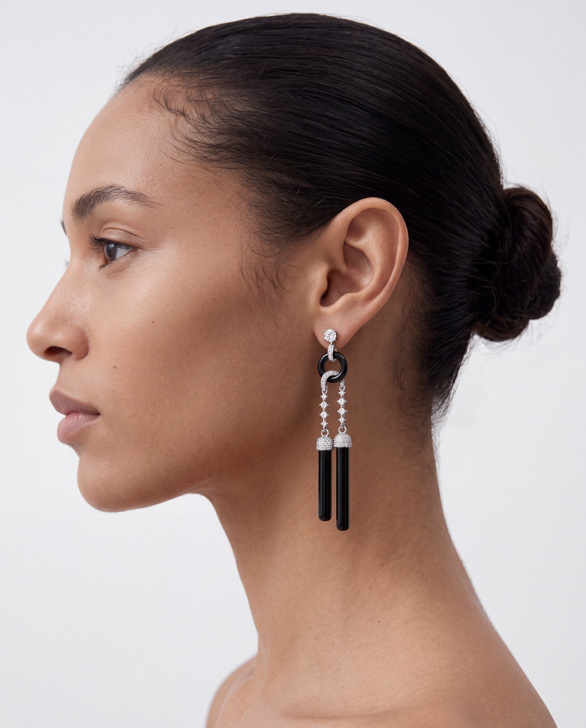 woman wearing black silver tassel statement earrings