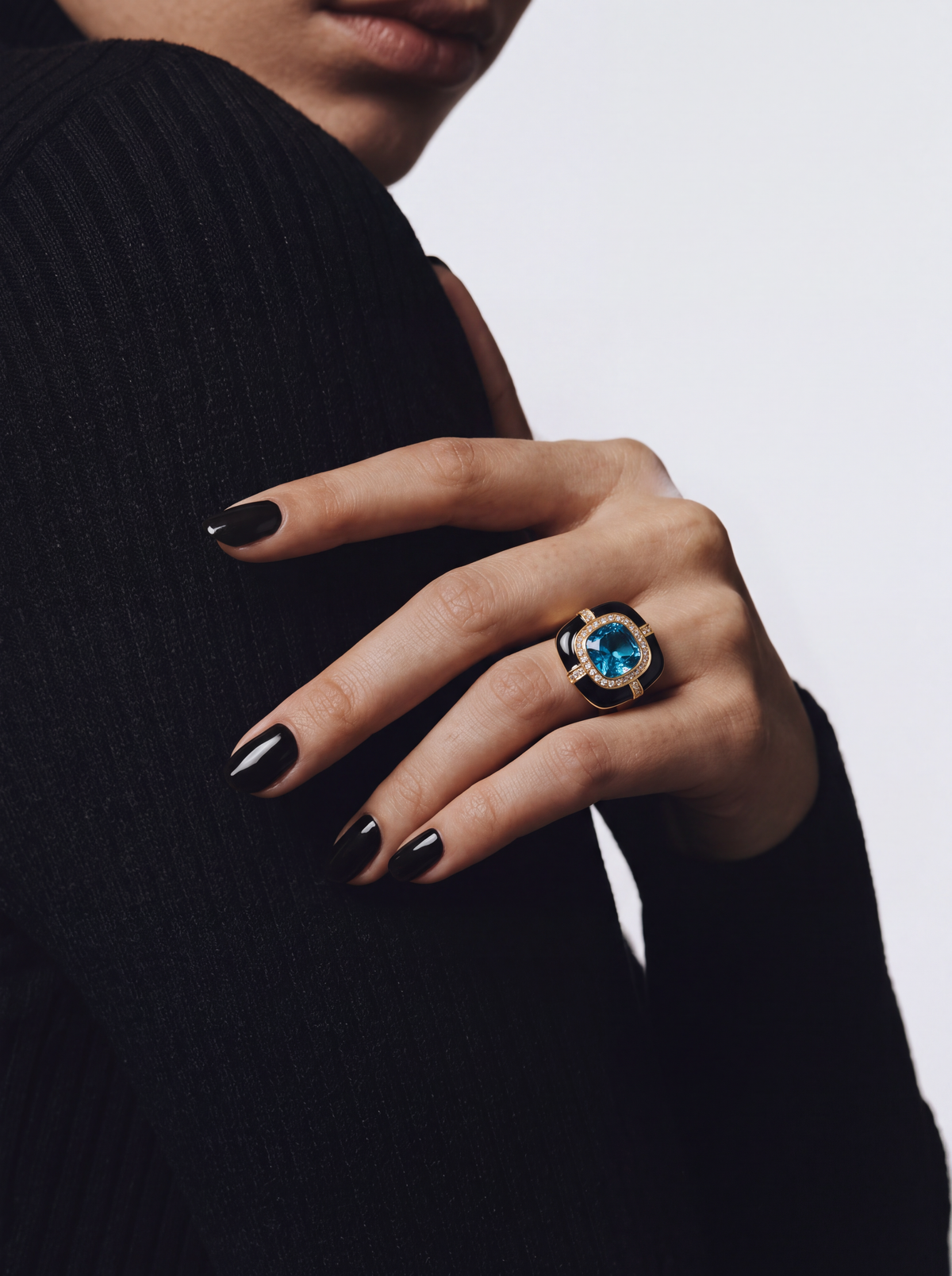 Blue faux gemstone statement ring worn on finger