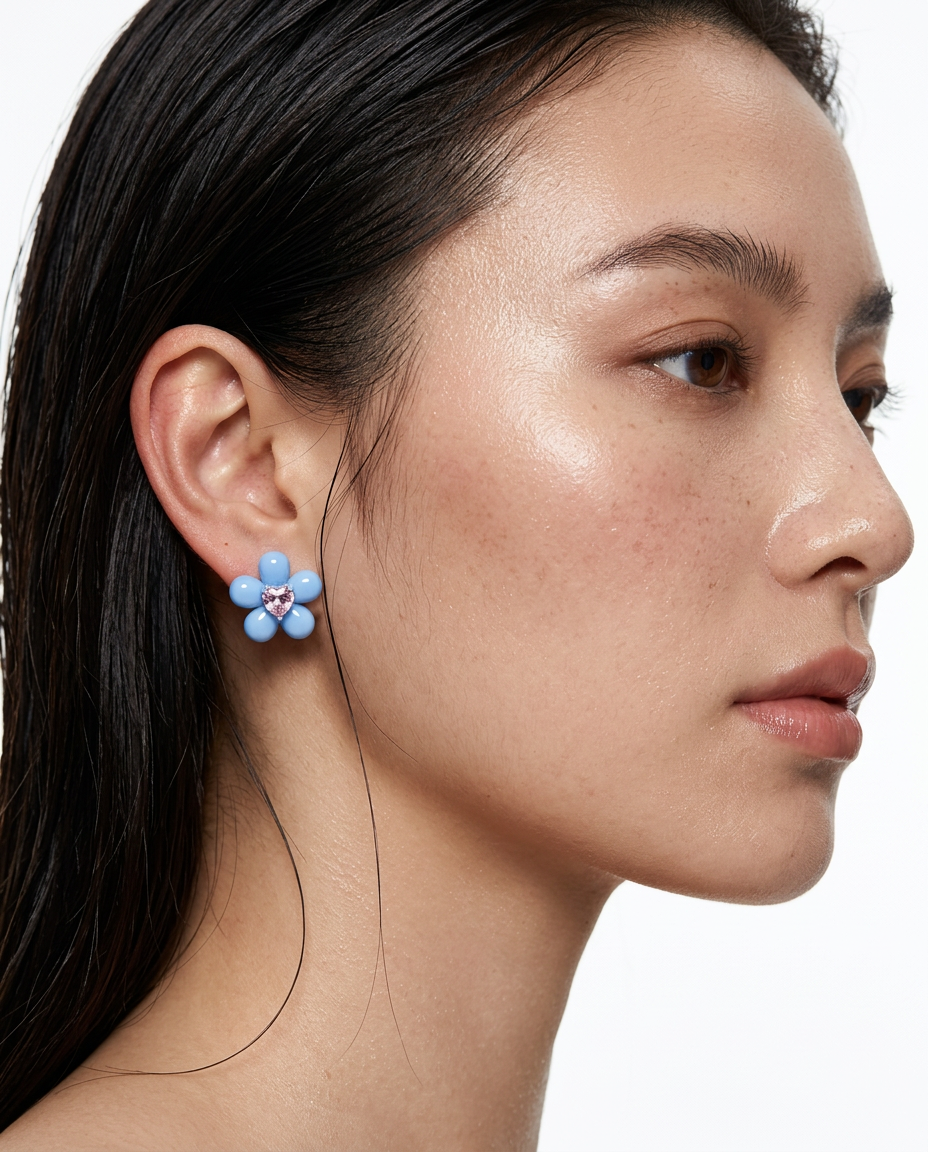 woman wearing blue flower stud earrings