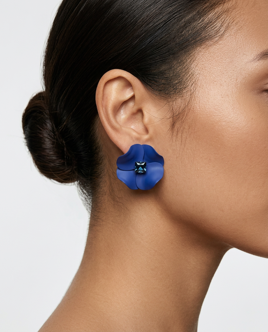 woman wearing blue 3D flower earrings