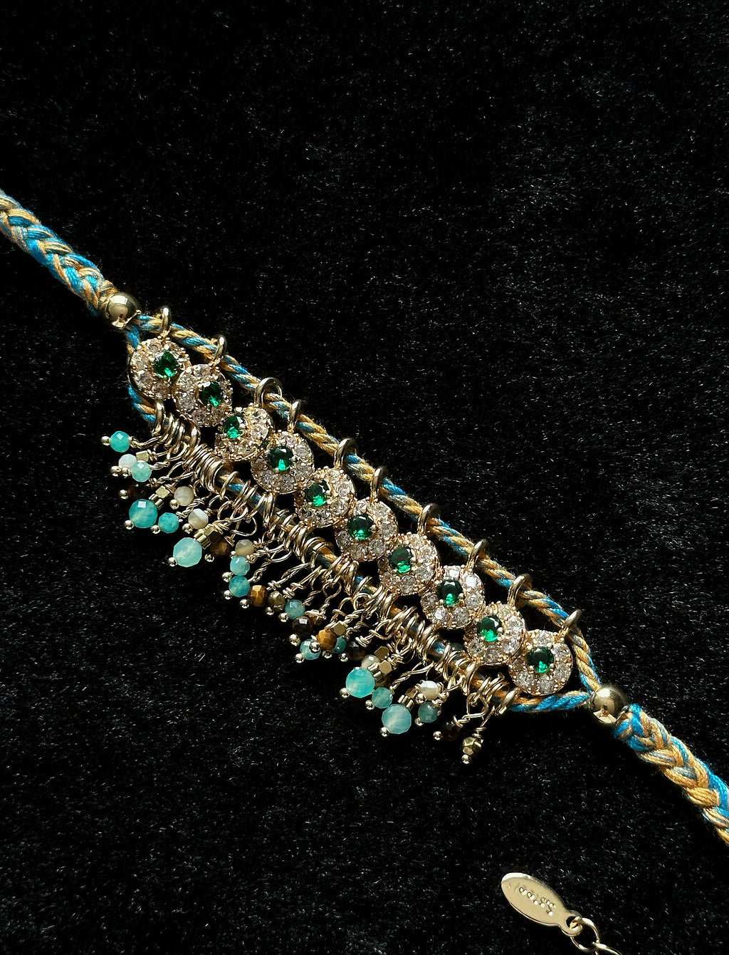 Braided rope bracelet with zircon accents and natural stone tassel details