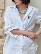 Faux turquoise necklace worn at collarbone