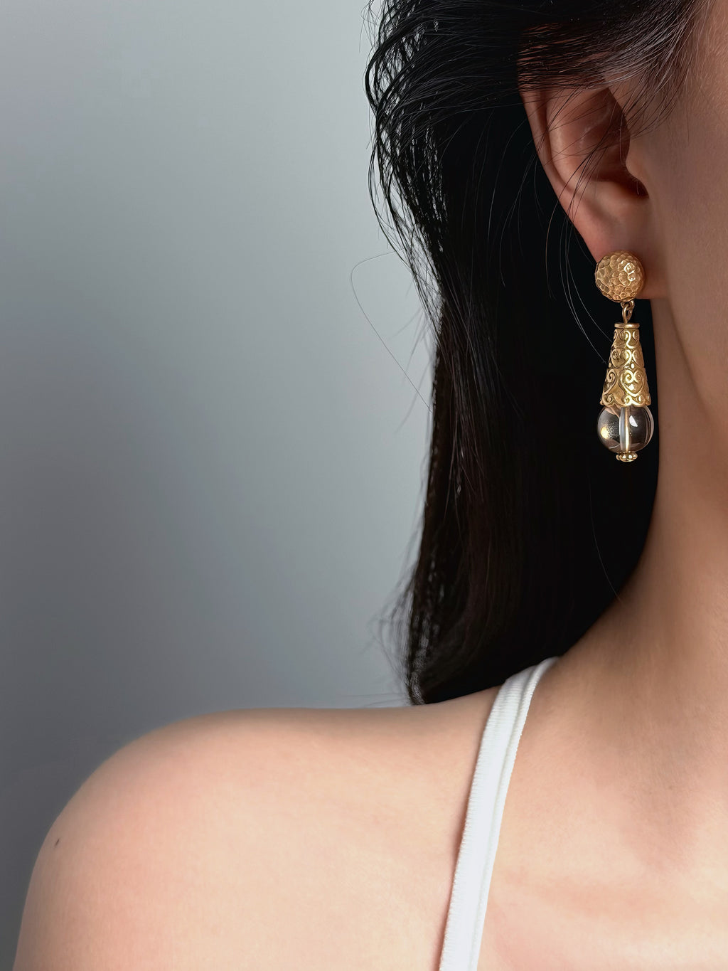 woman wearing French vintage gold drop earrings