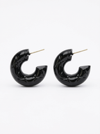 diamond patterned texture on black hoop earrings