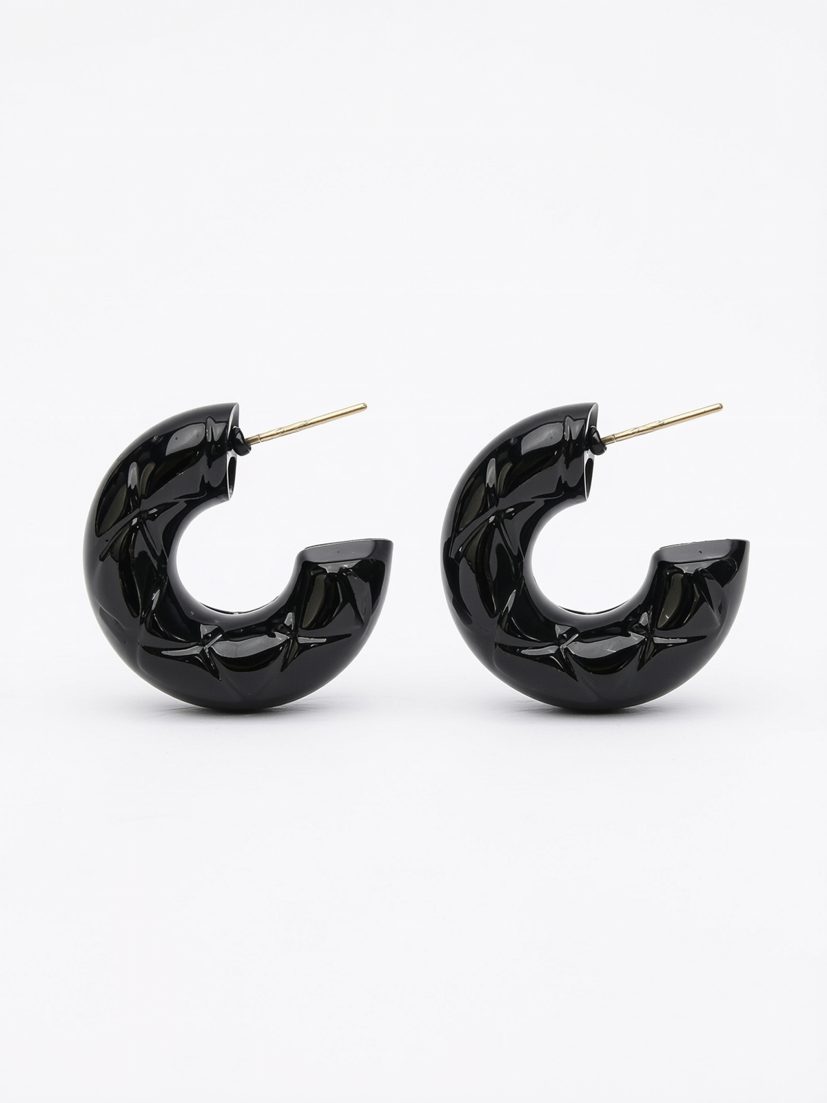 diamond patterned texture on black hoop earrings