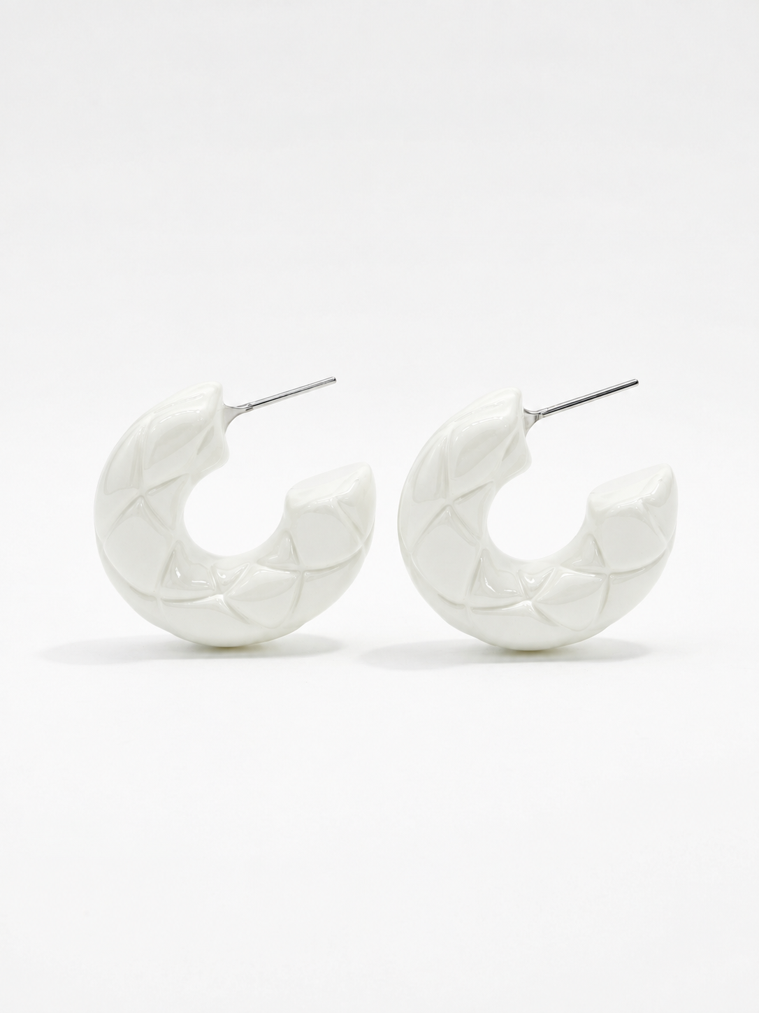 diamond patterned texture on white hoop earrings