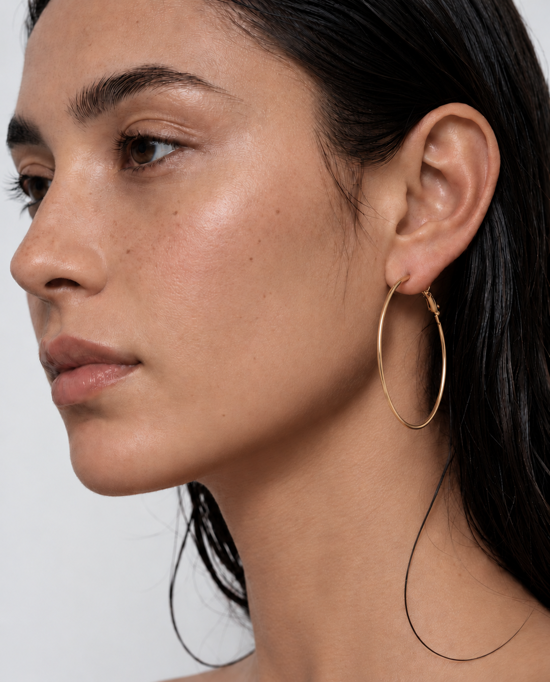 woman wearing  gold 5cm hoop earrings 