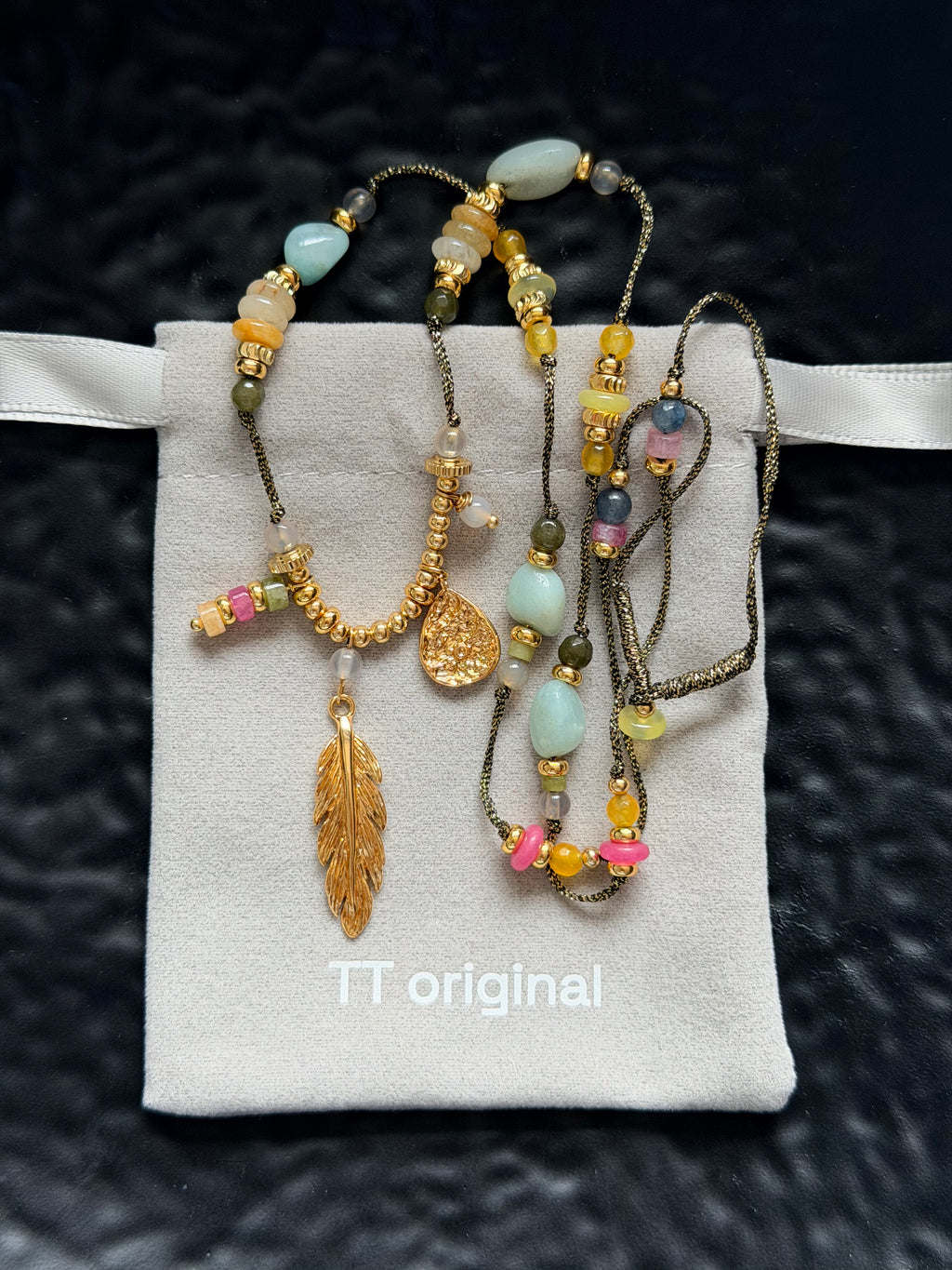 Gold feather tassel pendant on bohemian necklace