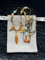 Gold feather tassel pendant on bohemian necklace