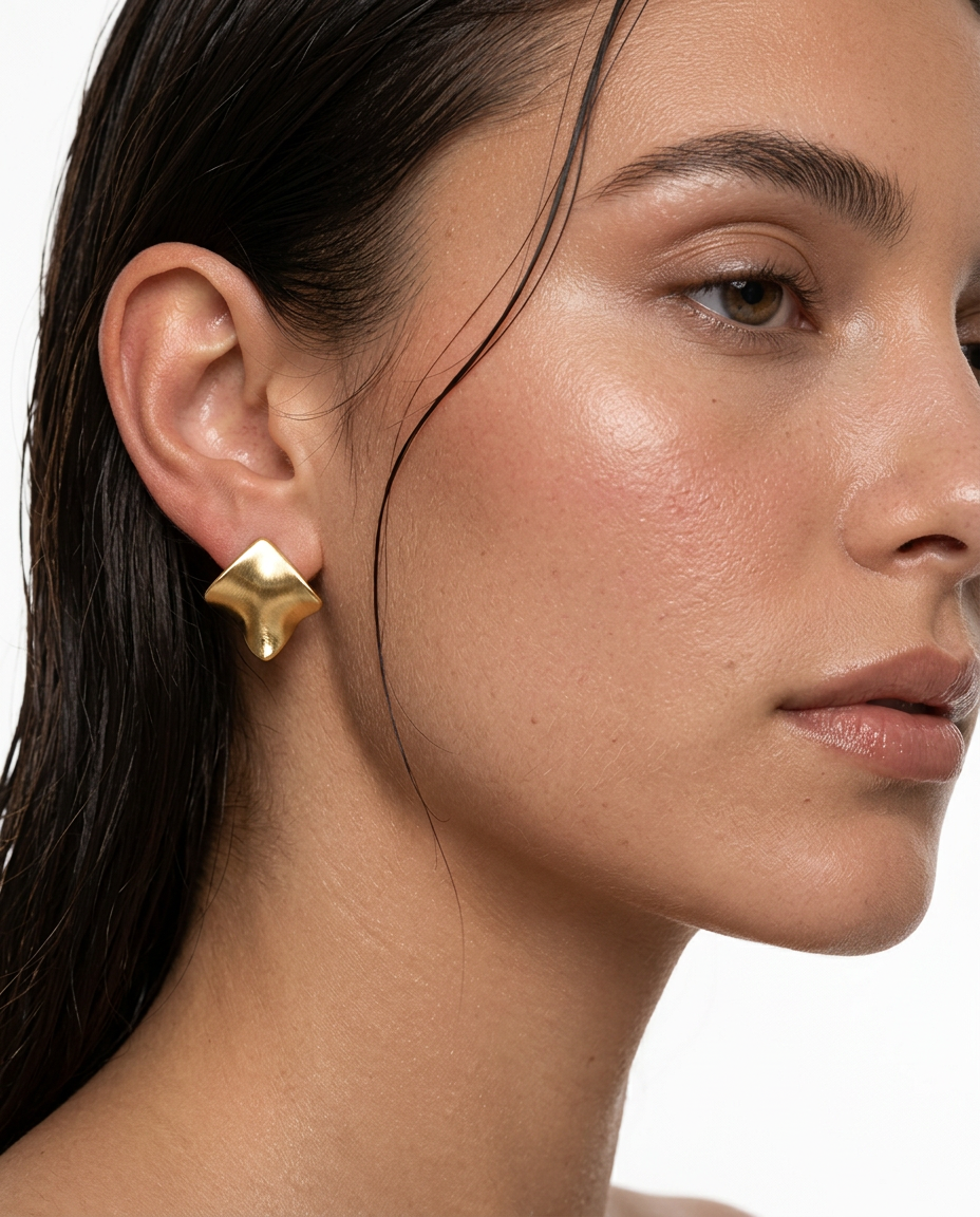 woman wearing gold geometric stud earrings