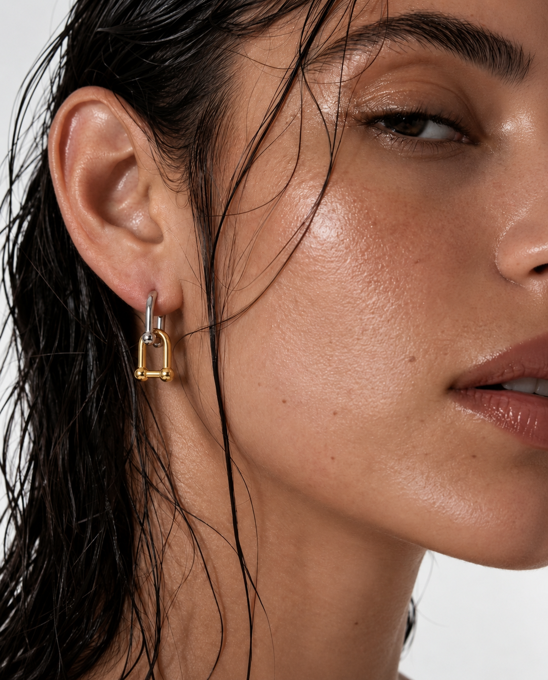 person wearing gold lock earrings