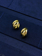 gold sculptural hoop earrings with curved metal lines