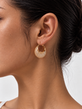woman wearing gold woven teardrop earrings