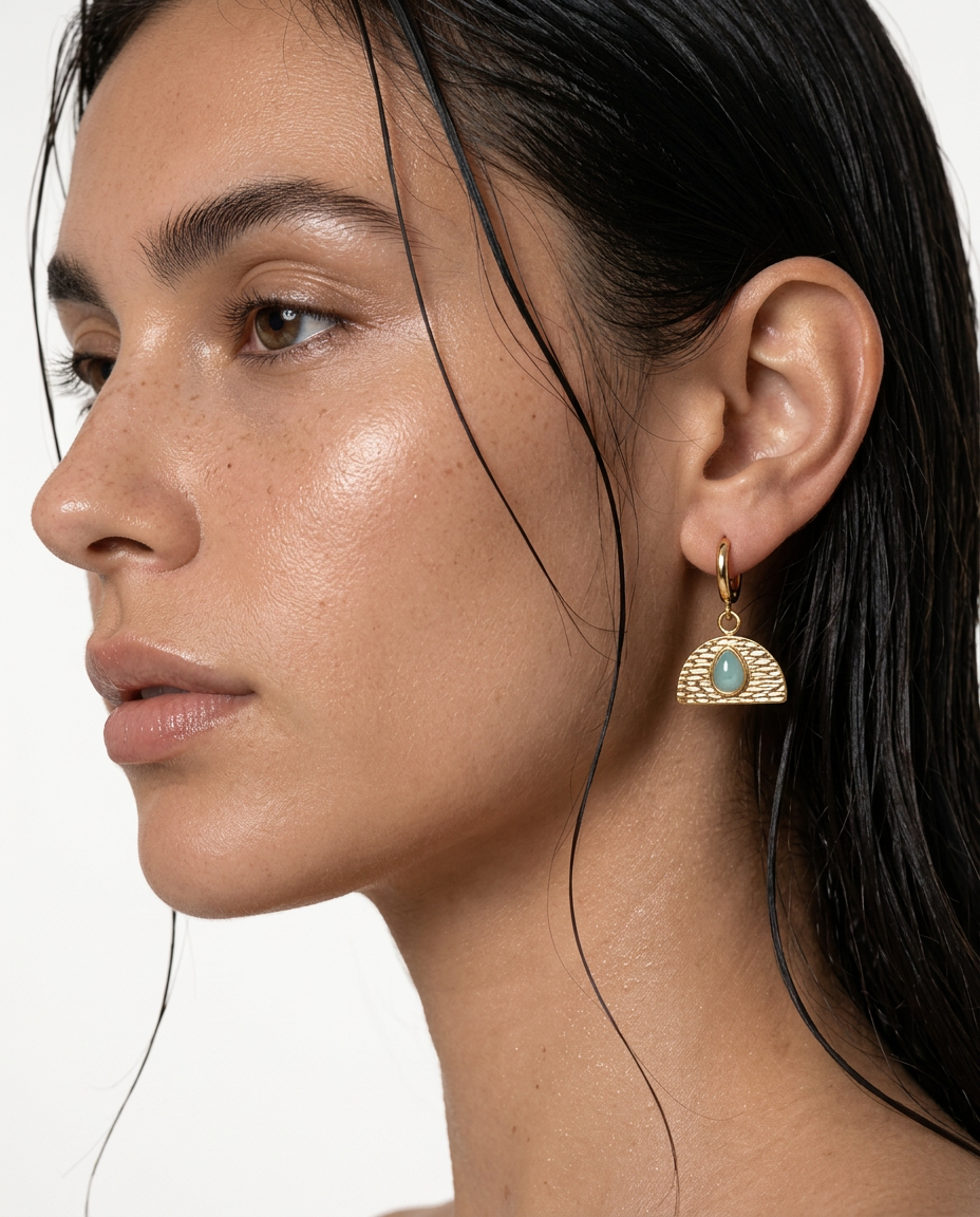 woman wearing green gemstone fan earrings