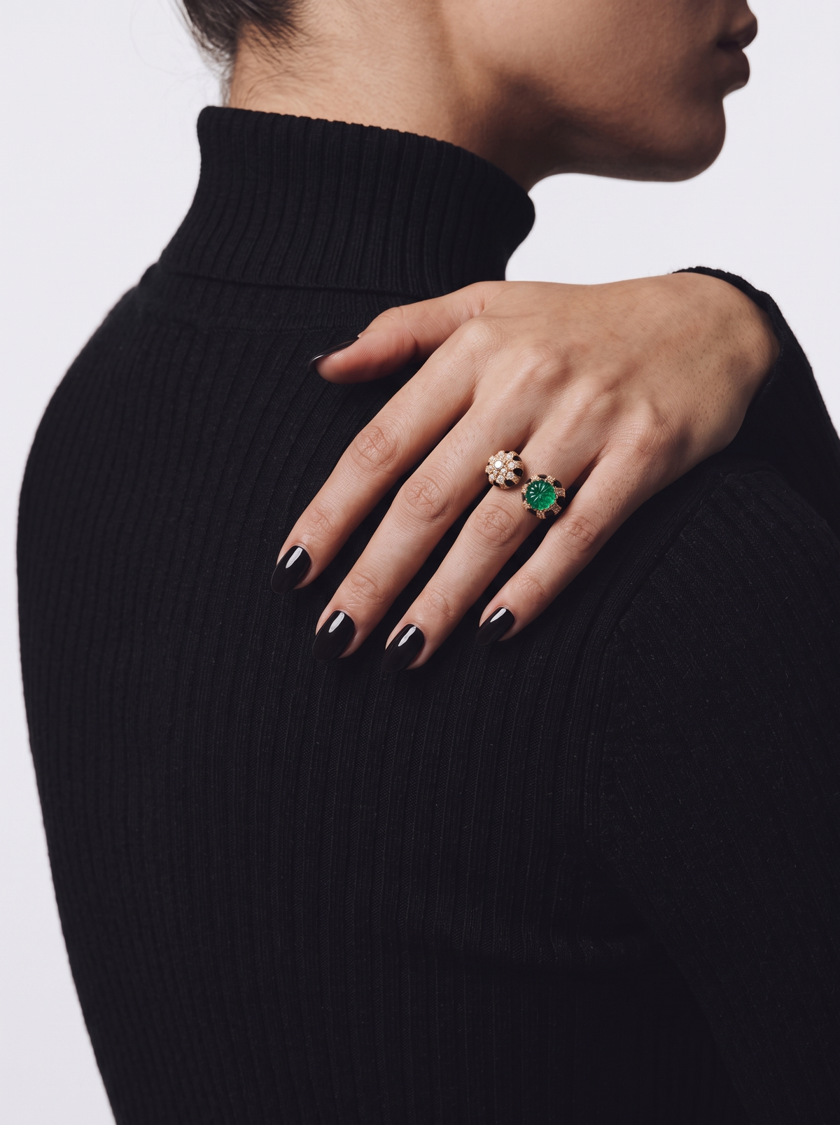 Green stone black and gold statement ring worn on finger