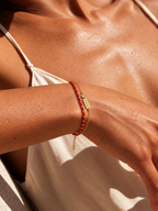 Lucky red string bracelet worn on the wrist