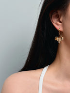 Woman wearing handmade bohemian natural stone tassel earrings