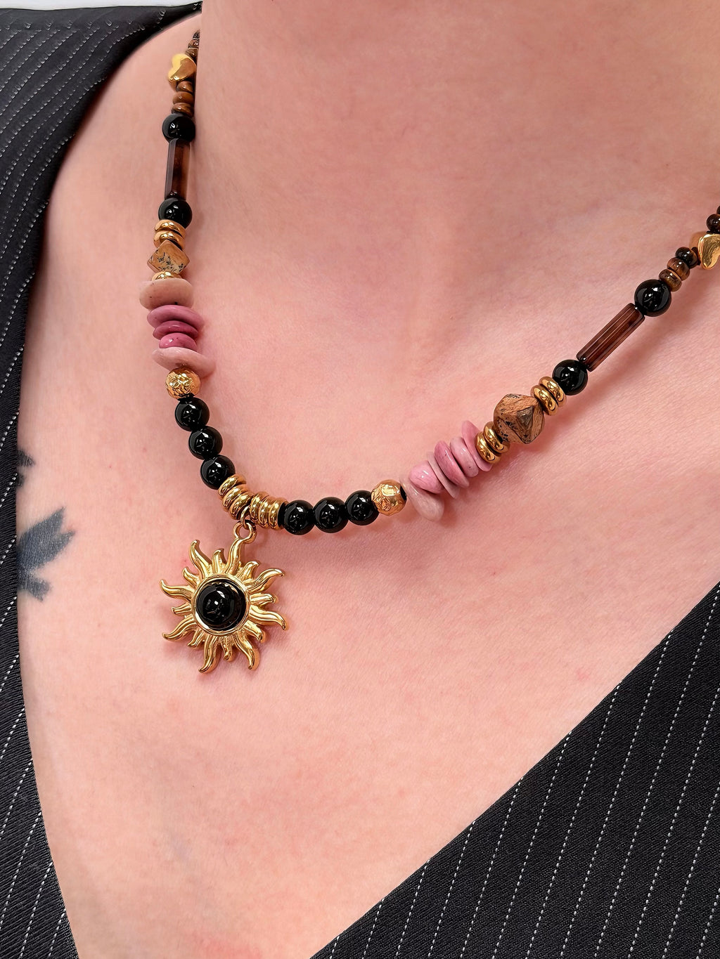 Mixed black pink and earth-tone beads on necklace