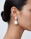 woman wearing natural baroque pearl drop earrings