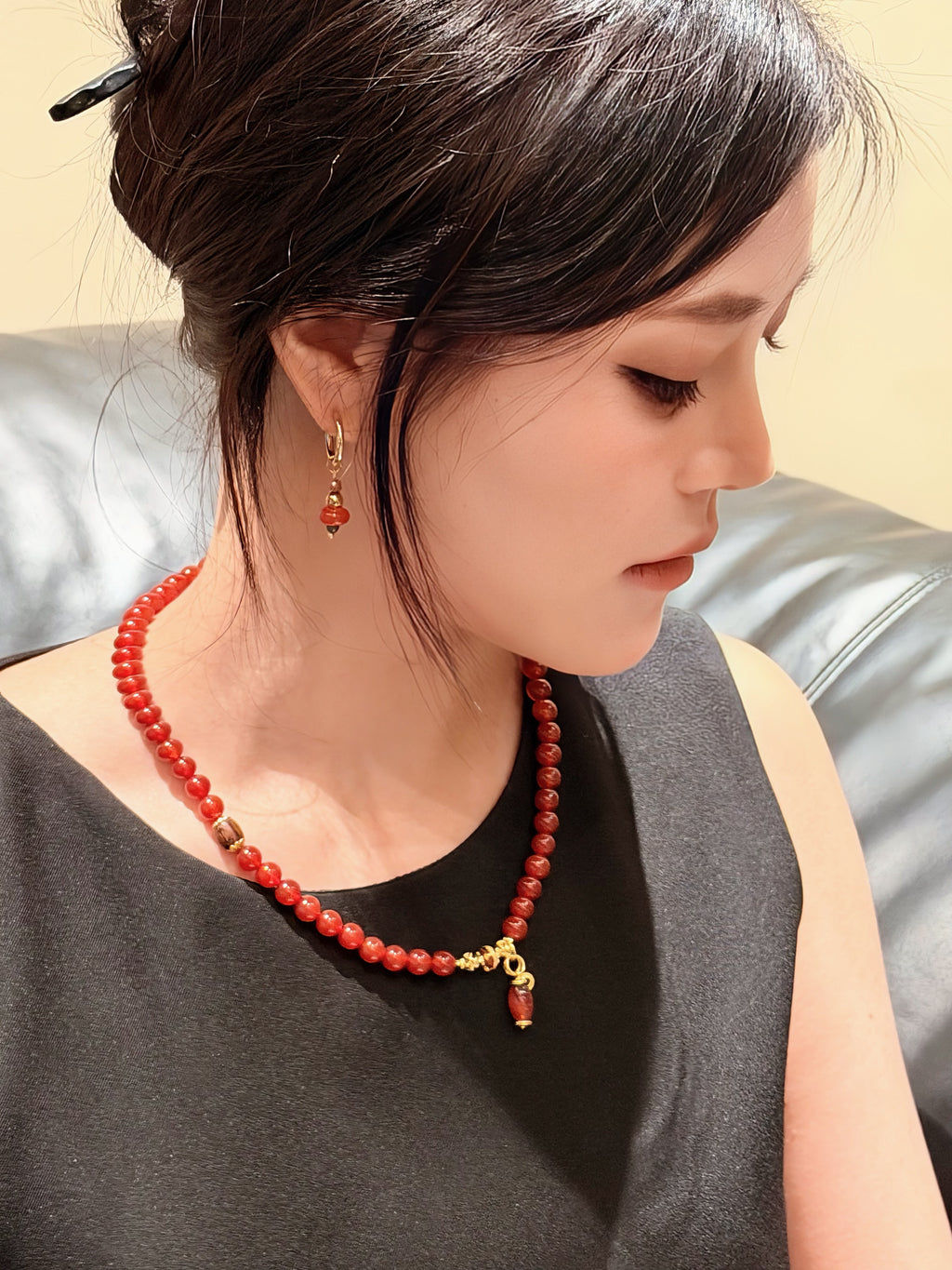 Natural red agate necklace worn as a single strand