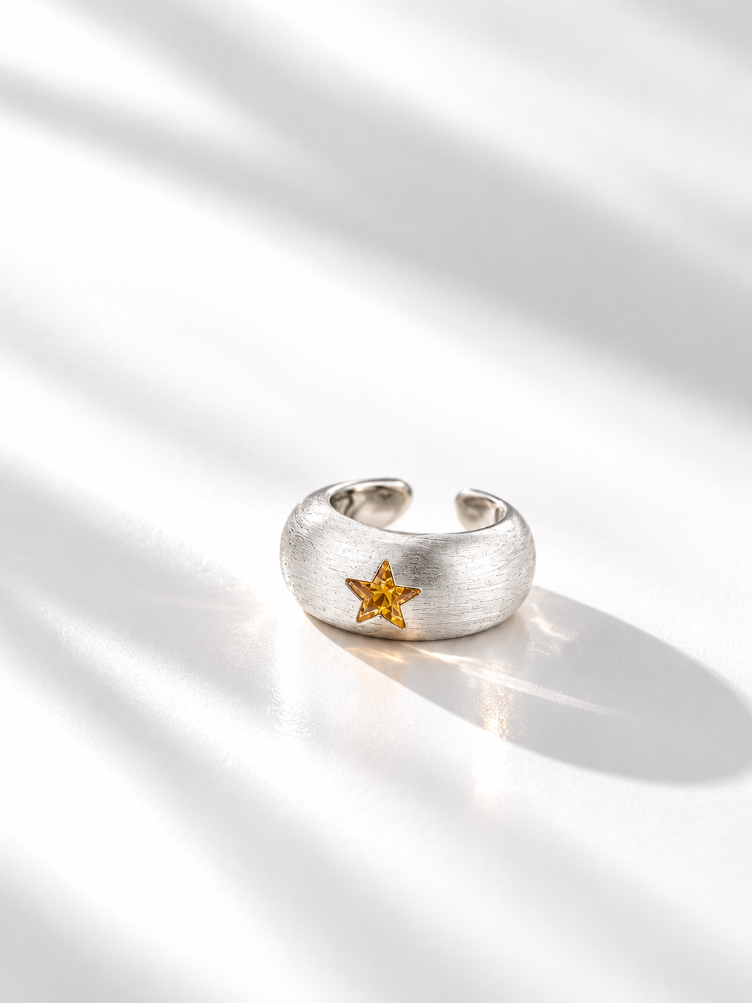 Front view of orange star CZ wide open ring