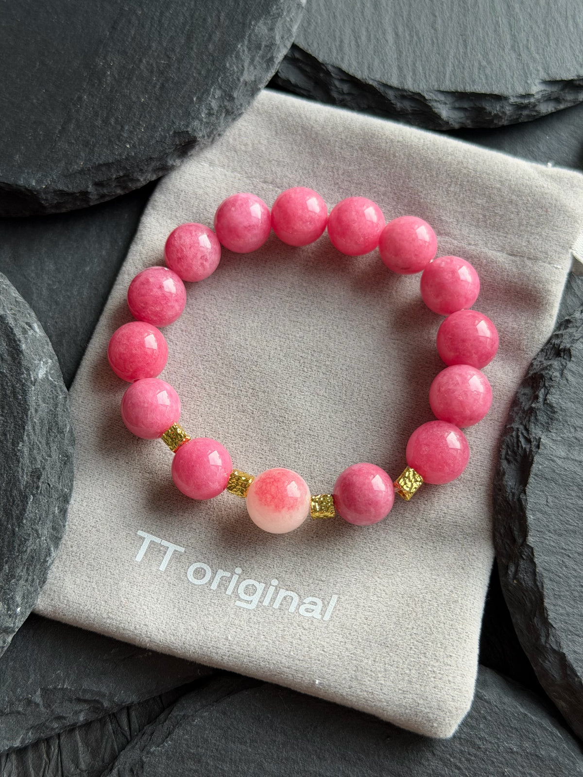 Pink natural stone bracelet with gold-tone accents