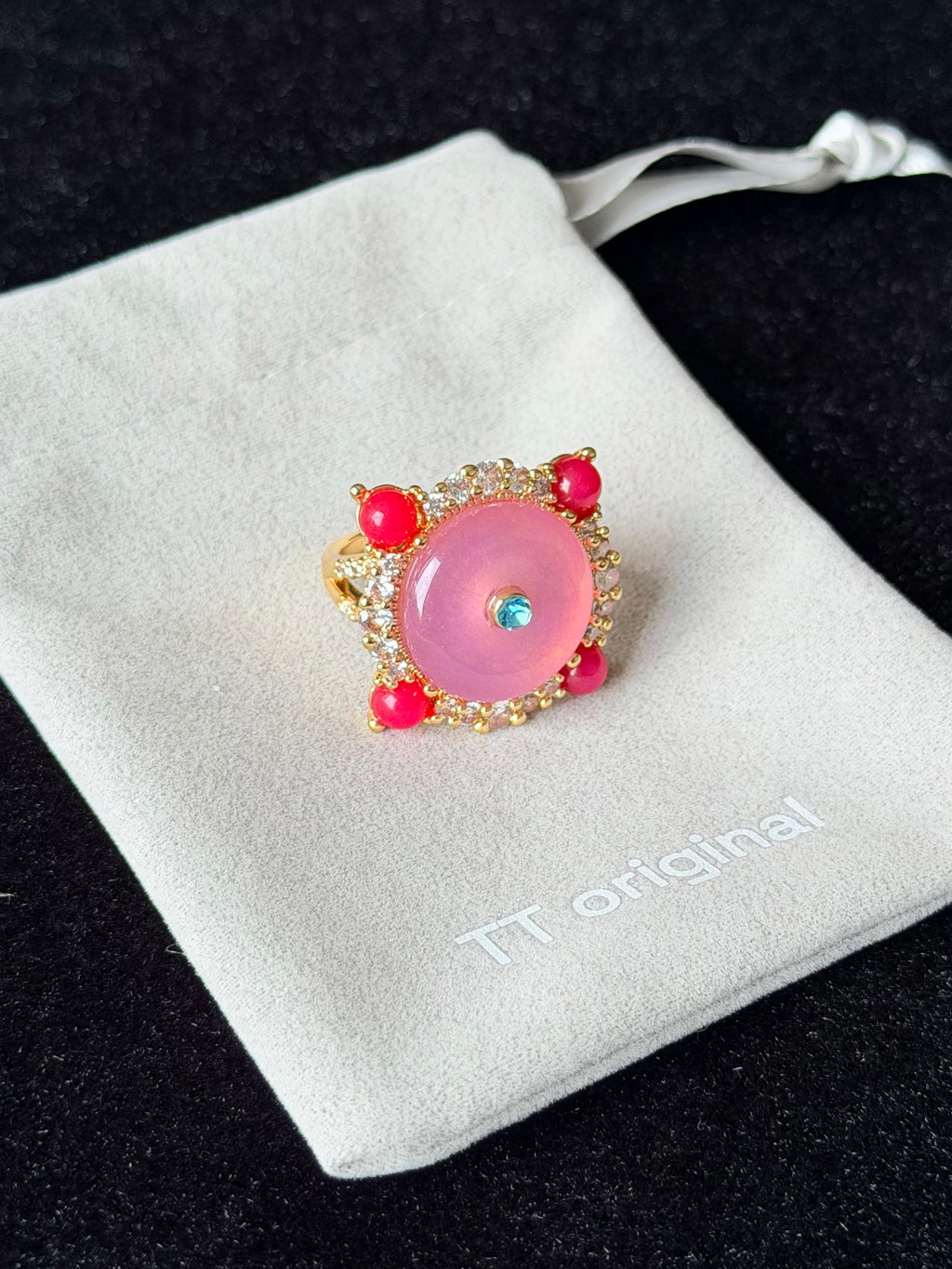 Side view of sculptural pink spiral ring