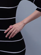 Pink spiral statement ring worn on hand