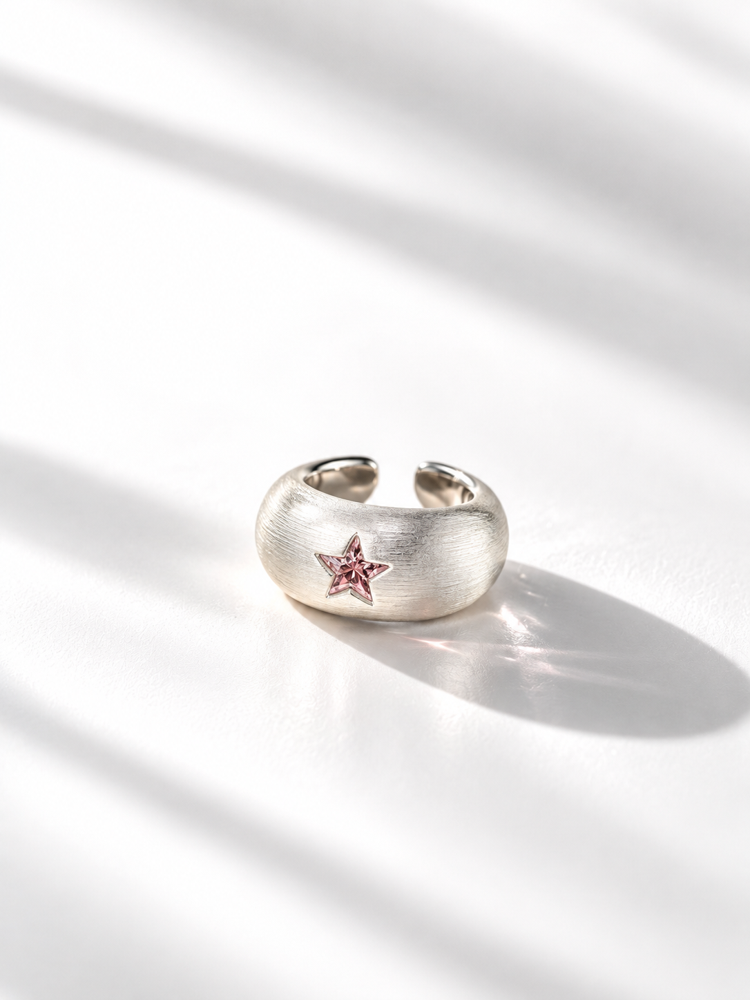 Front view of pink star CZ wide open ring