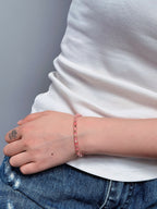 Pink watermelon quartz bracelet worn on the wrist