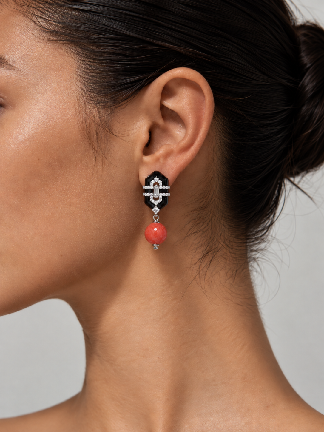 woman wearing red bead drop earrings