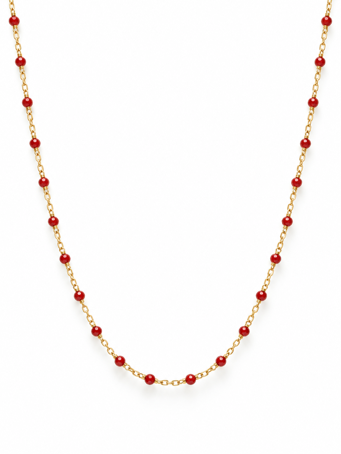 Bright red detailing on gold necklace