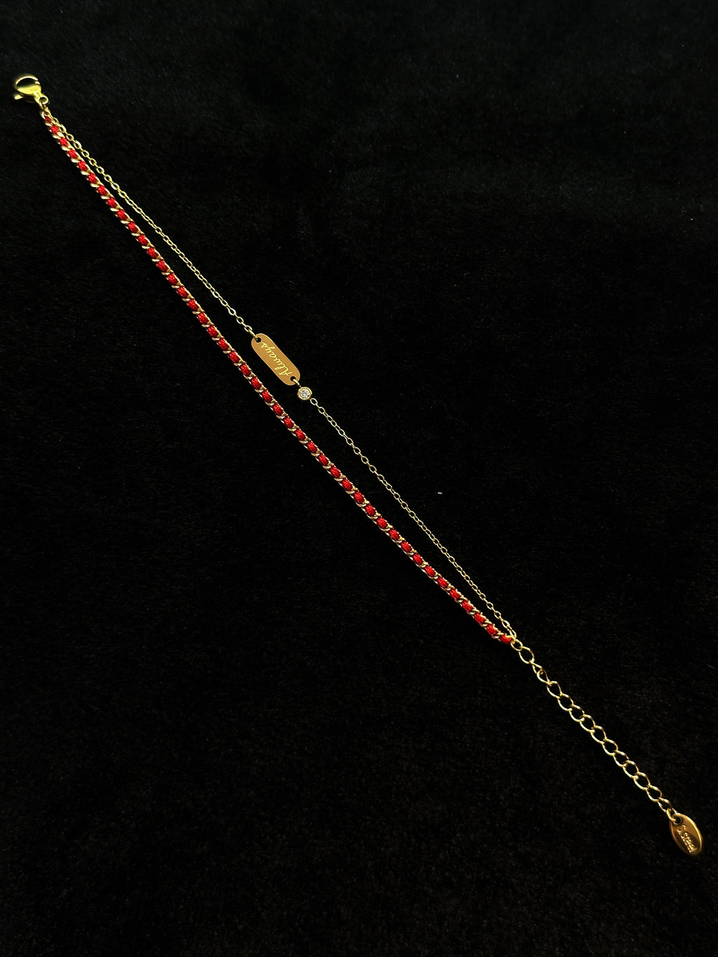 Red string detail on a lucky bracelet