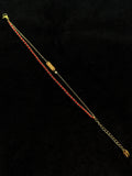 Red string detail on a lucky bracelet