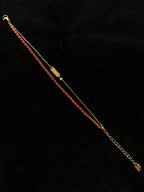 Red string detail on a lucky bracelet