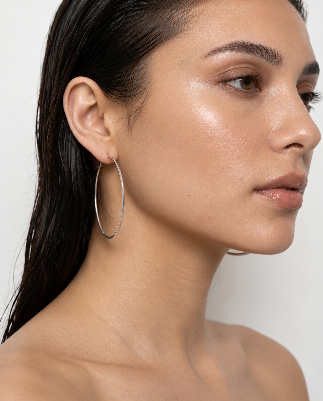 woman wearing  silver 5cm hoop earrings 