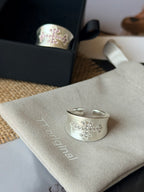 white accent details on silver cross ring