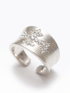 white accent details on silver cross ring
