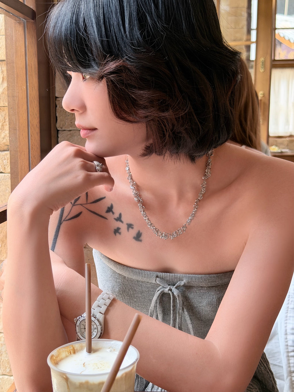 Silver crystal bubble necklace worn around the collarbone