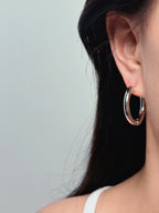 woman wearing classic silver hoop earrings