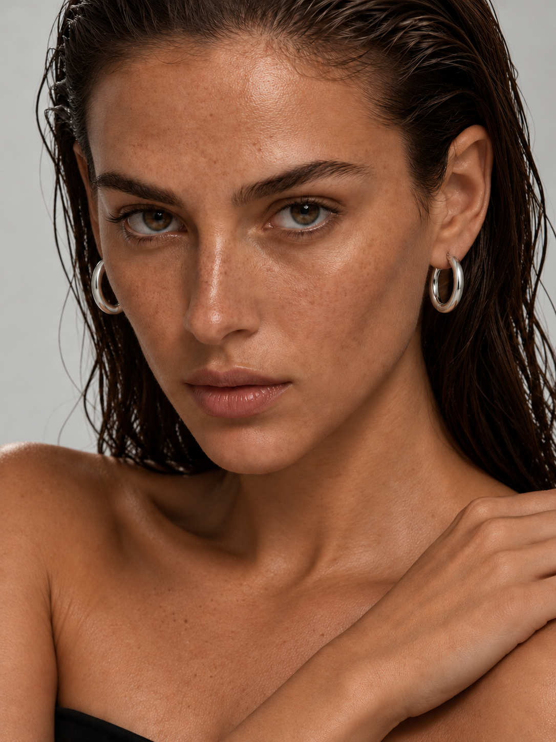woman wearing classic silver hoop earrings